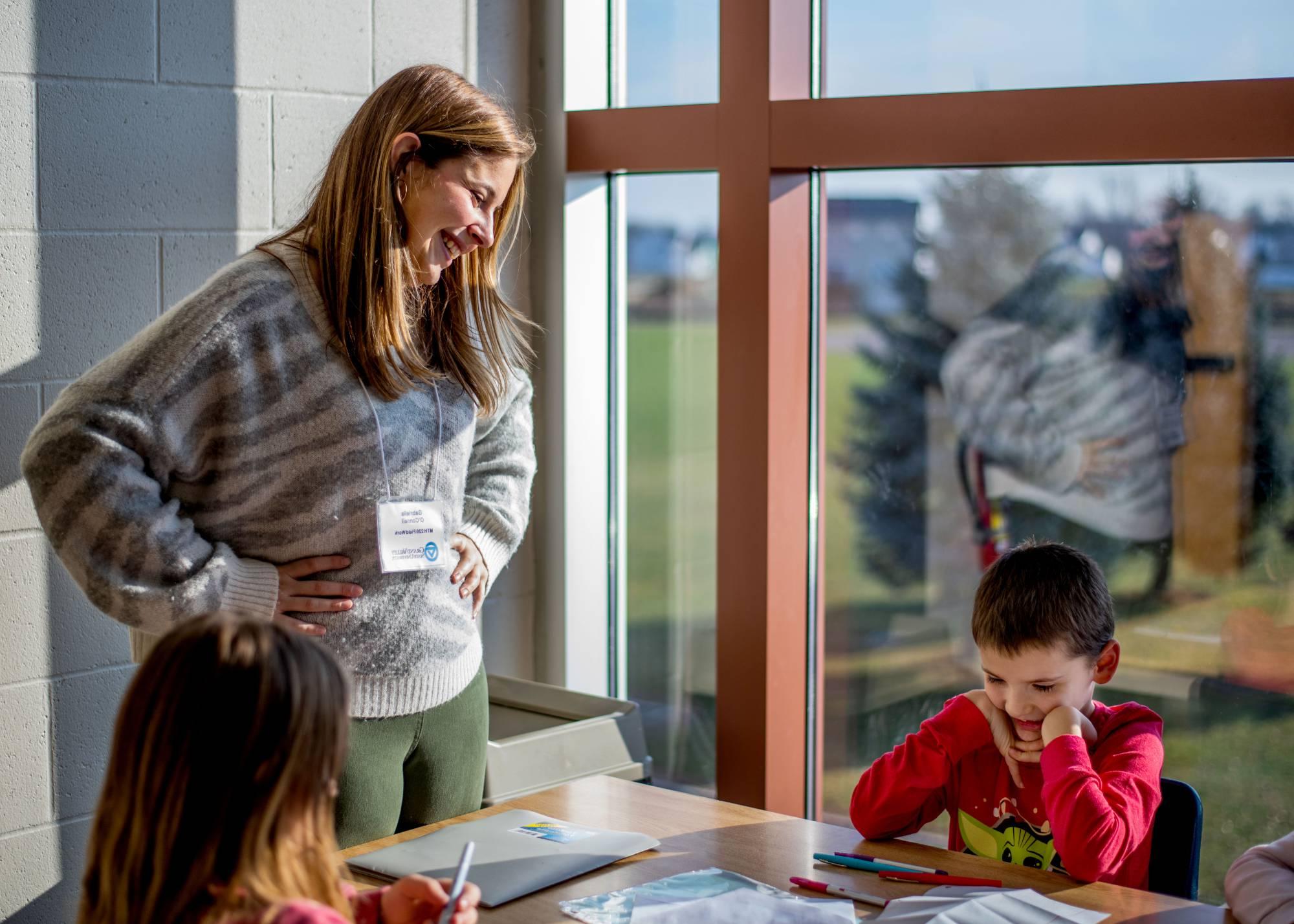 An elementary school teacher, teaching a class.